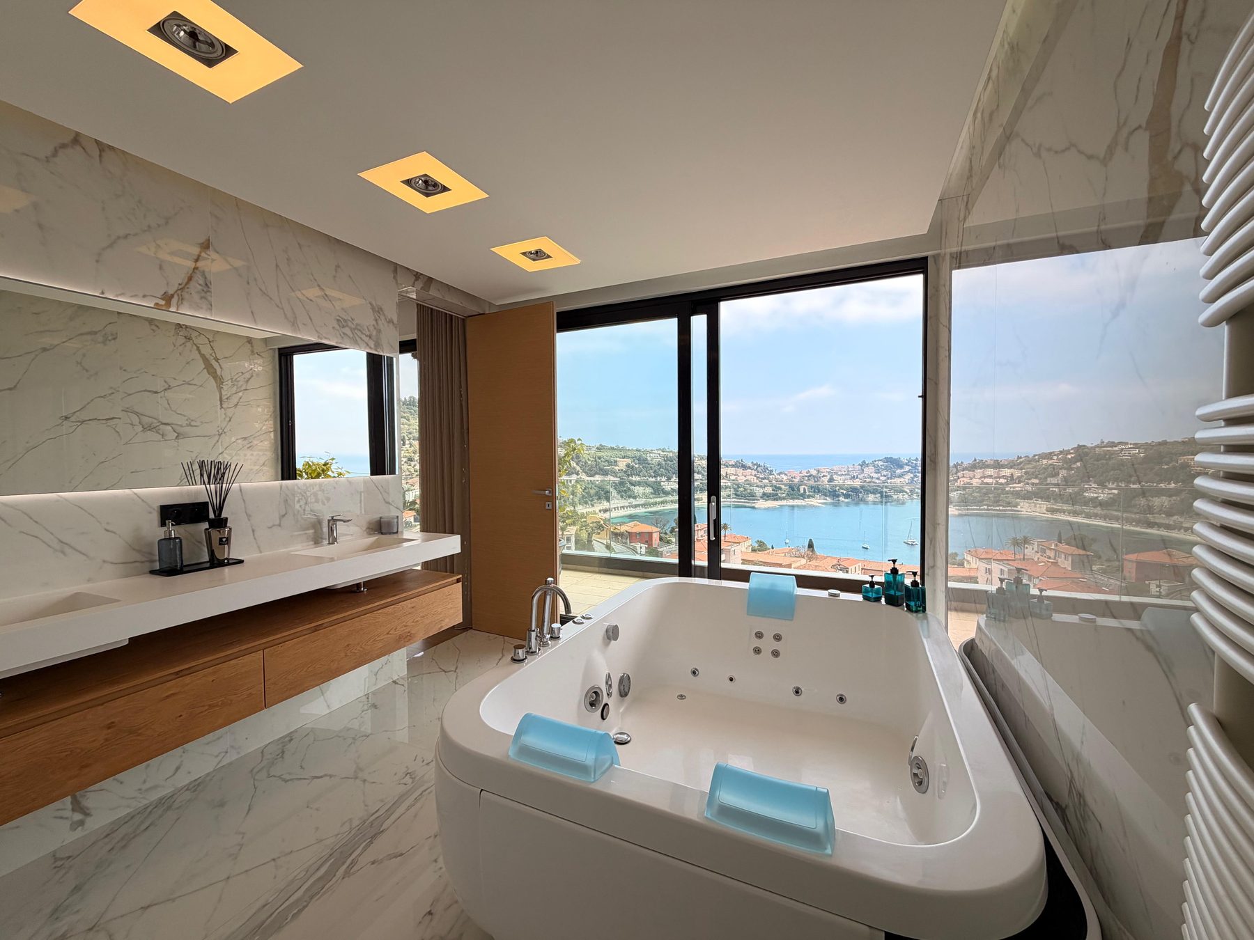 En-suite bathroom with a tub set against a window over the bay