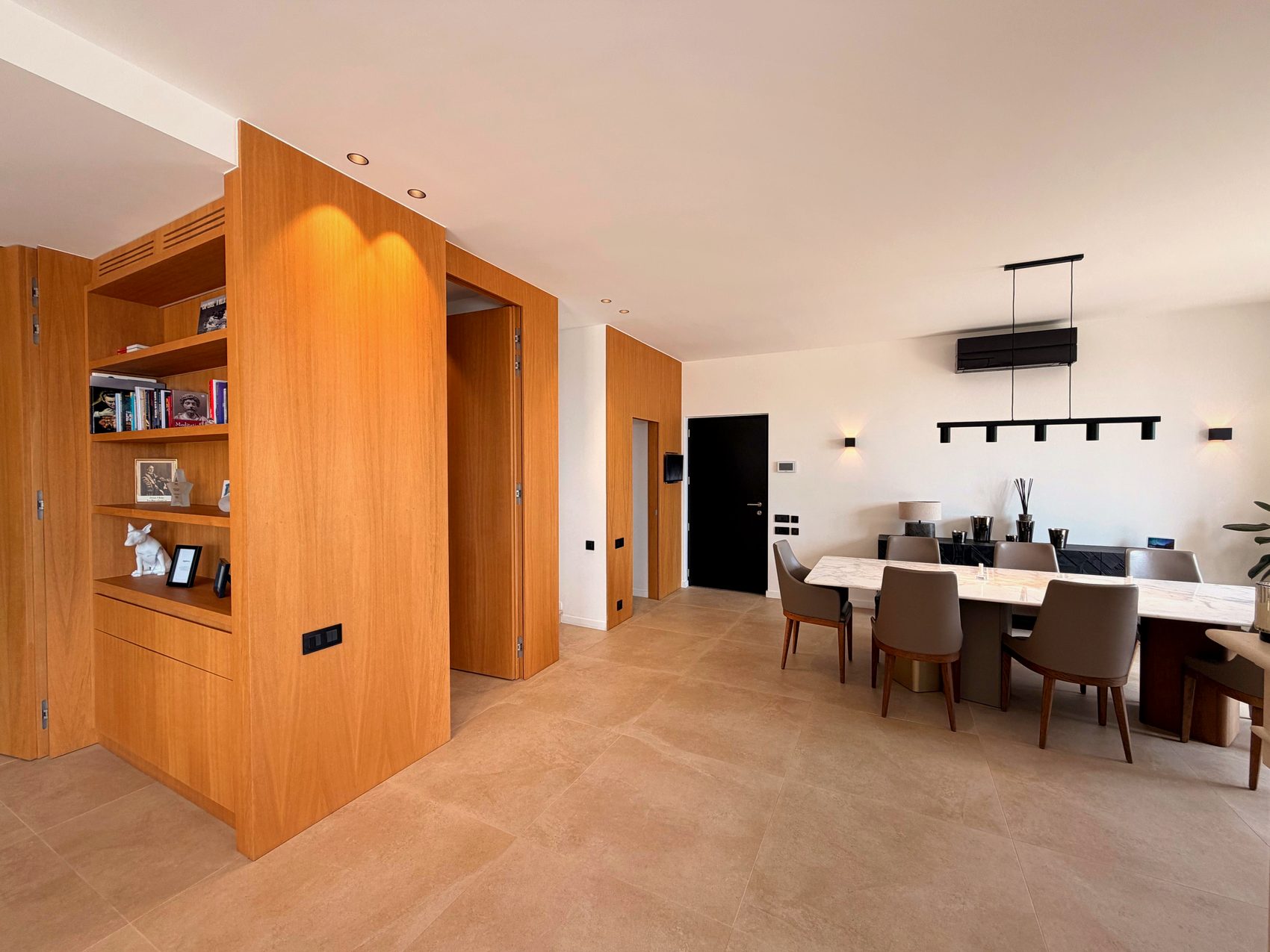 Entrance hall with fitted joinery and the dining area beyond