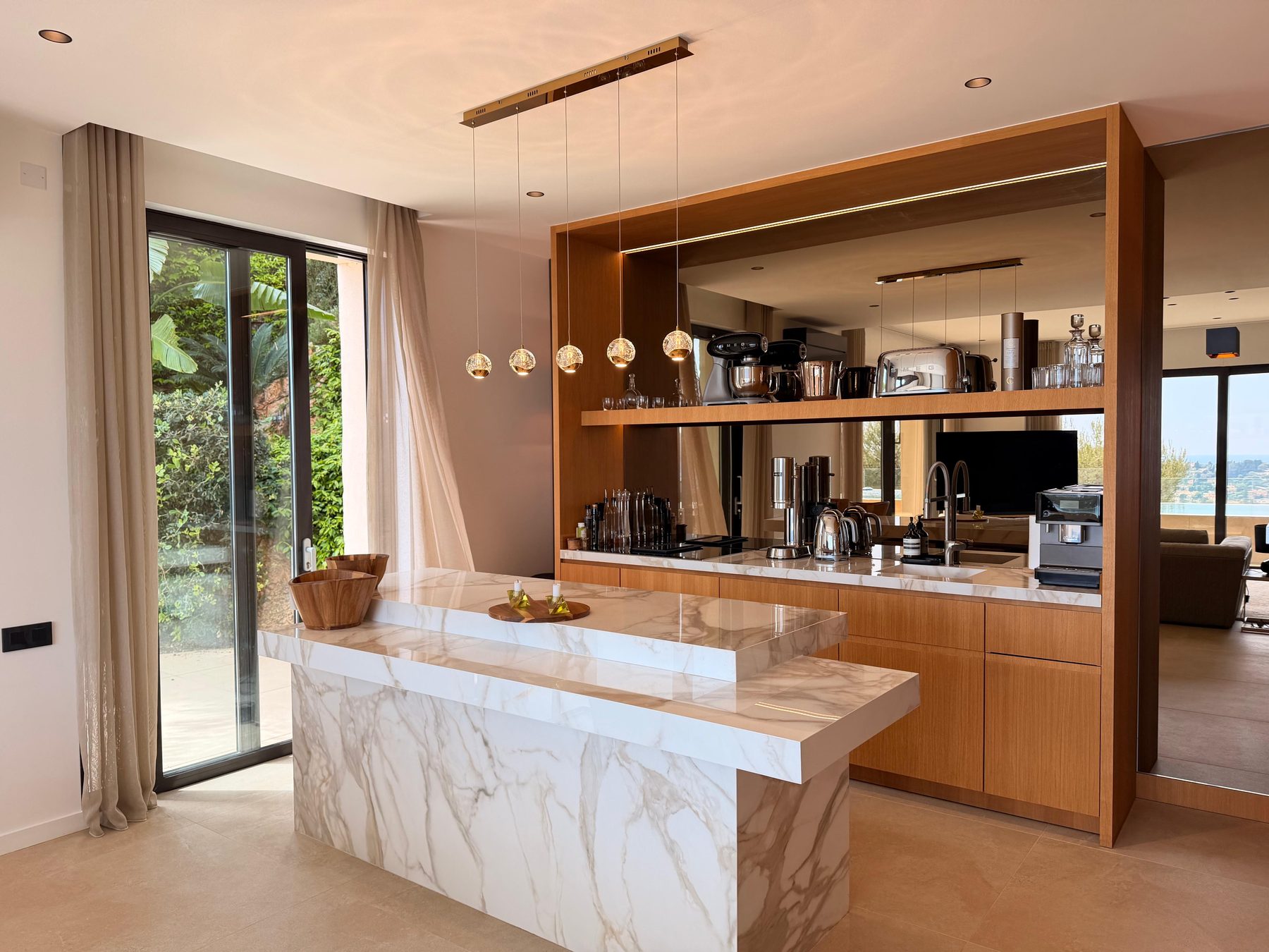 Open kitchen with a Calacatta marble island and oak cabinetry