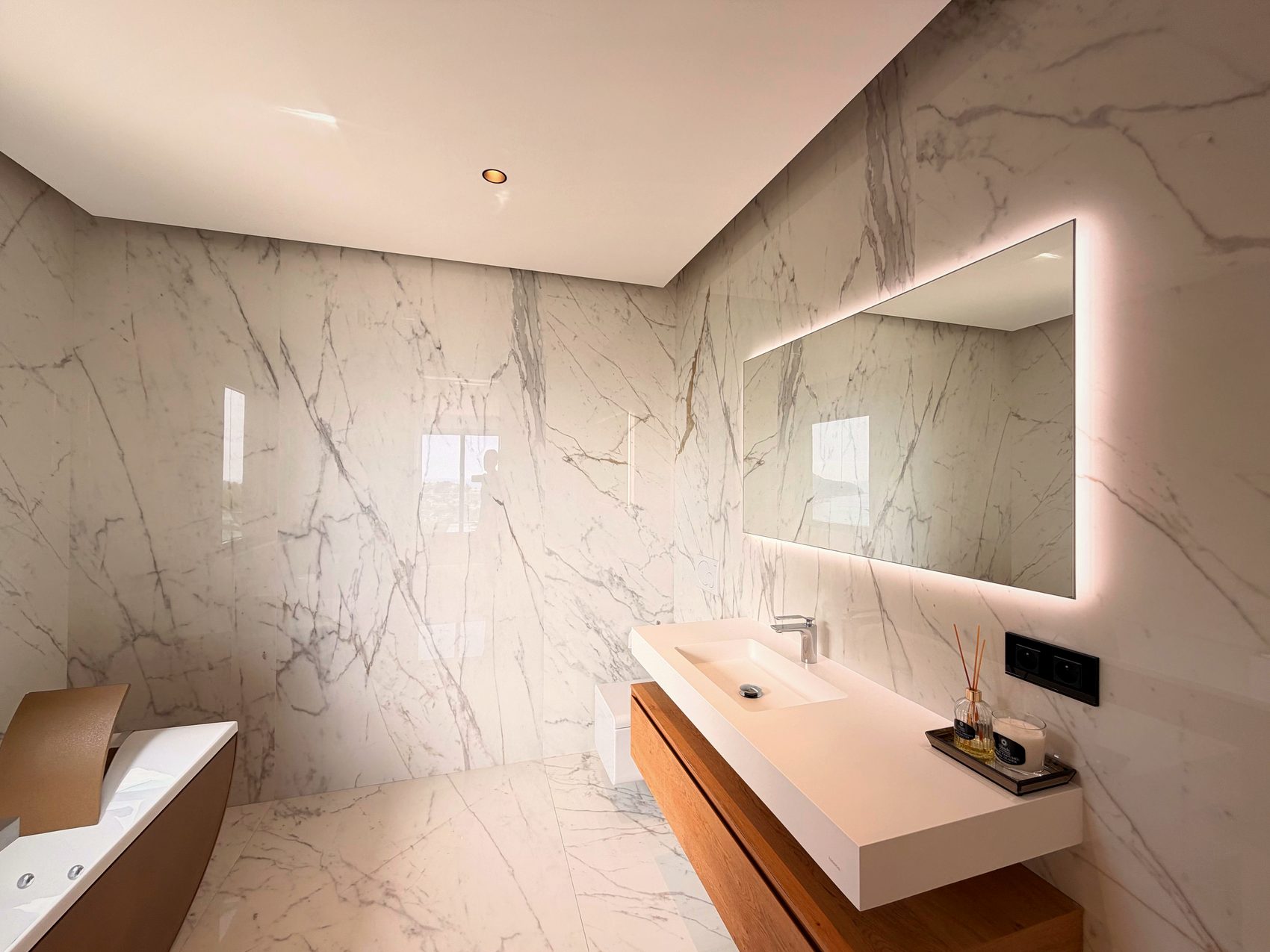 Walk-in rain shower in a stone bathroom