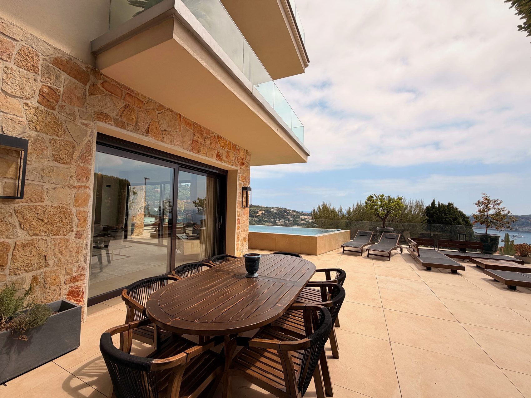 Outdoor dining table on the terrace beside the pool
